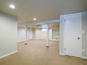 Basement featuring light colored carpet and recessed lighting