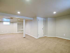 Basement with light colored carpet and recessed lighting