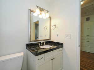 Bathroom featuring vanity and wood finished floors