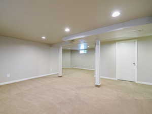 Basement with light colored carpet and recessed lighting