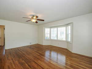 Empty room with ceiling fan and wood finished floors
