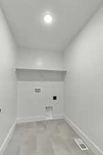 Washroom featuring baseboards and washer hookup