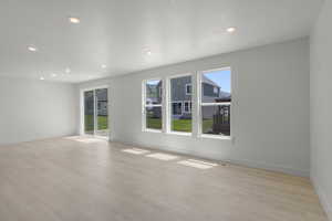 Living room featuring light wood-style flooring and recessed lighting