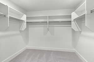 Walk in closet featuring carpet flooring