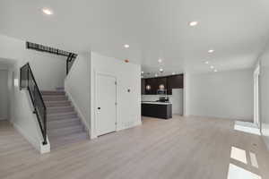 Living room featuring light wood-style flooring and recessed lighting