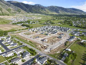 Aerial view of property's location featuring nearby suburban area and mountains