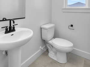 Bathroom featuring baseboards and tile patterned floors
