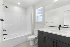 Full bath featuring vanity, shower / washtub combination, tile patterned flooring, and recessed lighting