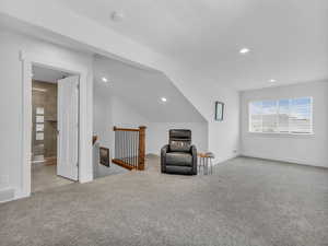 Unfurnished room with an upstairs landing, carpet floors, and recessed lighting