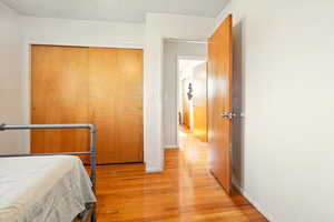 Bedroom featuring light wood-style floors and a textured ceiling