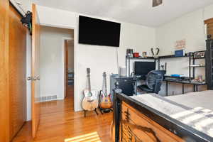 Bedroom featuring wood finished floors and a textured ceiling