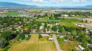 Aerial view of property and surrounding area with a mountainous background
