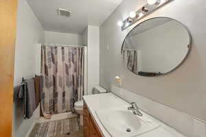 Bathroom featuring vanity, wood finished floors, and a shower with curtain