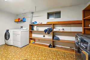 Laundry room with washing machine and dryer and light flooring