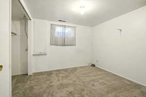 Unfurnished bedroom with carpet and a closet