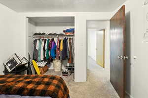 Bedroom with carpet floors and a closet