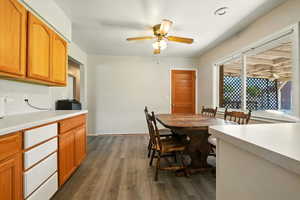 Dining area featuring dark wood-style flooring and a ceiling fan
