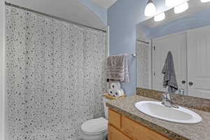 Full bath featuring vanity and curtained shower