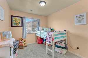 Carpeted bedroom with baseboards and a textured ceiling