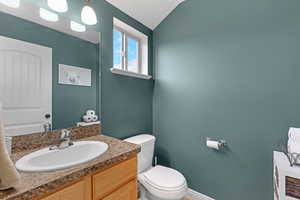 Half bathroom featuring toilet and vanity