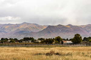 View of mountain backdrop with rural landscape