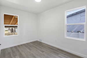 Empty room with plenty of natural light and wood finished floors