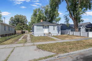 Bungalow-style home with a chimney and driveway