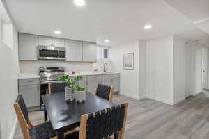 Dining area with light wood-style flooring and recessed lighting
