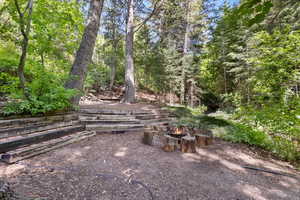 View of yard with an outdoor fire pit