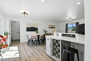 Kitchen and dining area, wine rack, and bar/ desk area