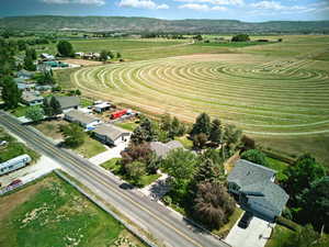Aerial view of sparsely populated area and open field behind