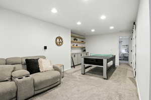 Game room with light colored carpet and recessed lighting