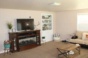 Living room with carpet flooring and baseboards