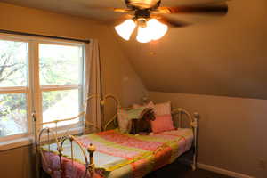Bedroom with lofted ceiling, carpet, and a ceiling fan