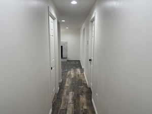 Hall with recessed lighting and dark wood-style floors