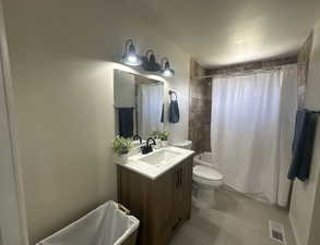 Bathroom featuring vanity, shower / bathtub combination with curtain, and tile patterned flooring