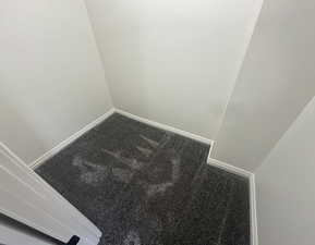 Detailed view of carpet flooring and baseboards