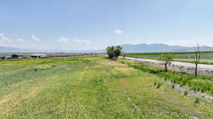 View of yard featuring a view of rural / pastoral area and a mountain view