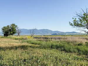 View of mountain backdrop with rural landscape