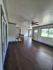 Foyer entrance featuring hardwood / wood-style flooring, ceiling fan, and a textured ceiling