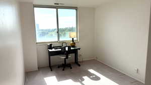 Carpeted office space with baseboards