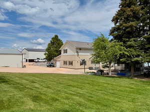 Rear view of house with a lawn