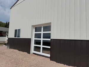 40x60 Steel shop w/ glass garage door view to lake