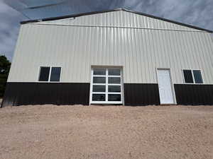 40x60 Steel shop w/ glass garage door view to lake