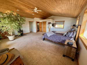 En suite Bedroom with a gas fireplace, lofted wood ceiling, and ceiling fan
