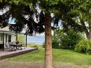 South side of home with covered deck and lake view