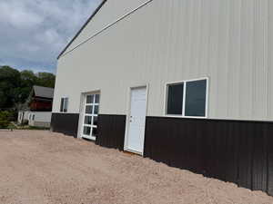 40x60 Steel shop w/ garage door view to lake and man door