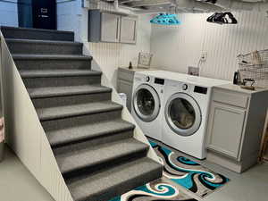 Laundry room with independent washer and dryer and cabinet space