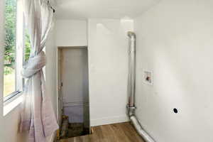 Laundry room with hookup for an electric dryer, washer hookup, wood finished floors, and plenty of natural light