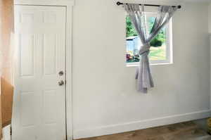 Detailed view of baseboards and wood finished floors
